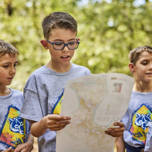 cub scouts at the lake boys looking at a map